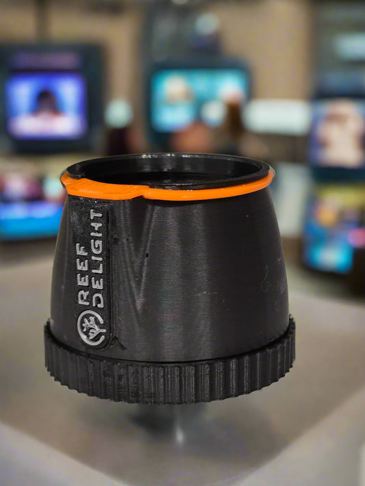 Black and orange cylindrical object with 'REEF DELIGHT' branding on a neutral background
